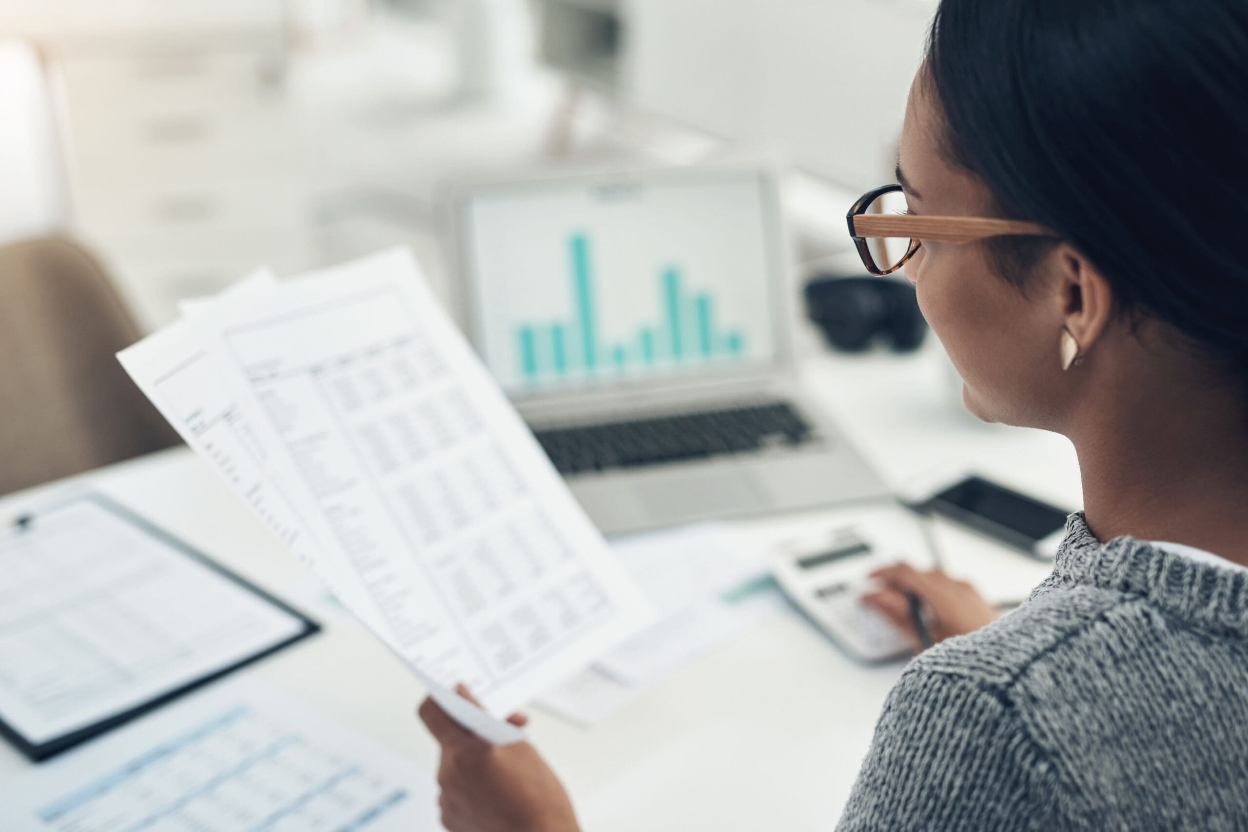 Closeup shot of an businesswoman calculating finances in an office
